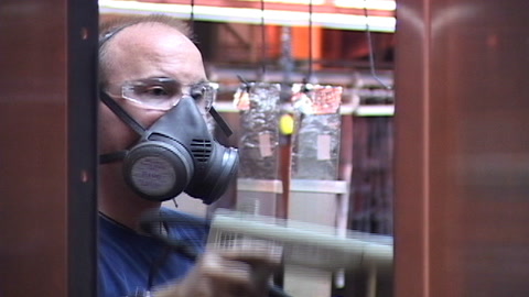 Screen shot of video with man wearing a respirator