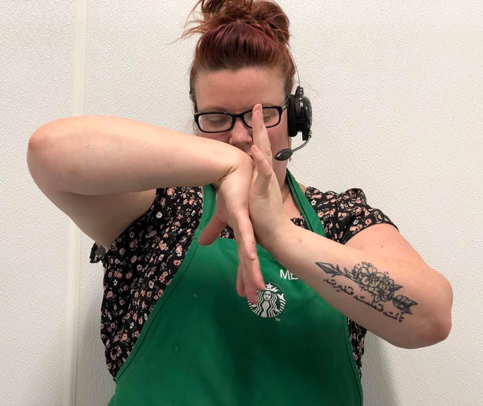 Photo of Starbucks employee doing wrist stretching